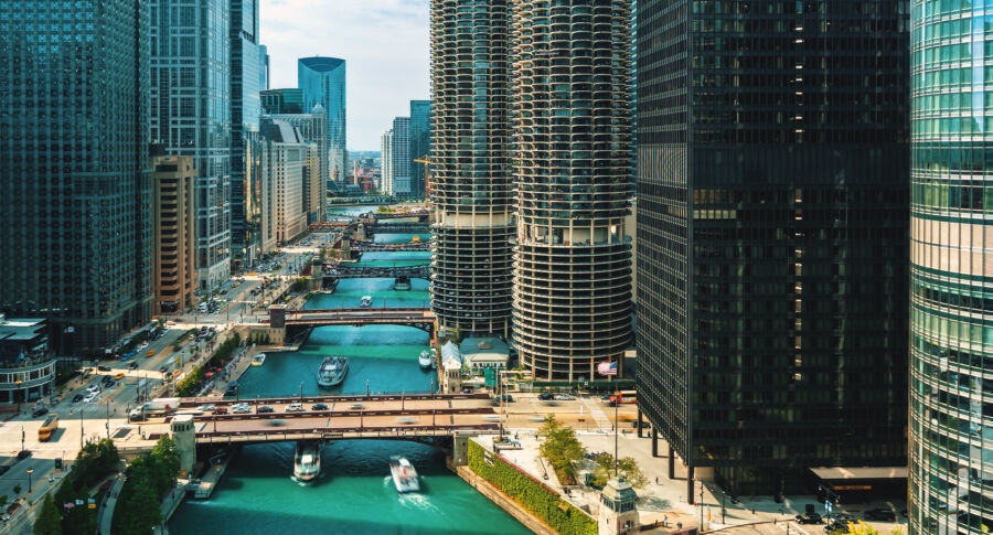 Morning aerial perspective of the Chicago River, featuring boats and traffic amidst the vibrant cityscape