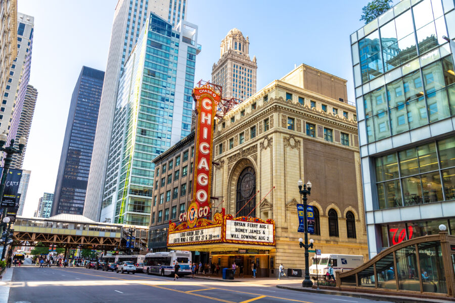 The iconic Chicago Theatre sign illuminates the historic building, showcasing its architectural grandeur and vibrant atmosphere