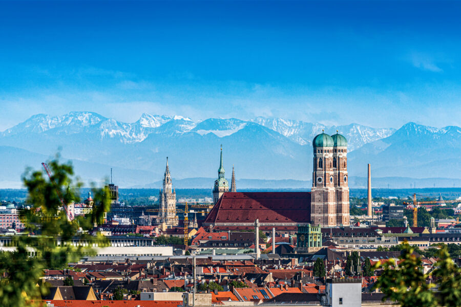 Munich's summer cityscape features charming architecture and a bustling atmosphere, all under a bright blue sky