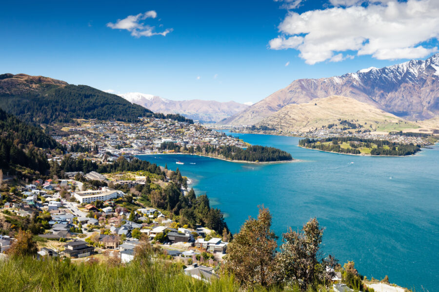 Bright sunny day in Queenstown, New Zealand, highlighting the picturesque scenery and vibrant natural beauty of the area