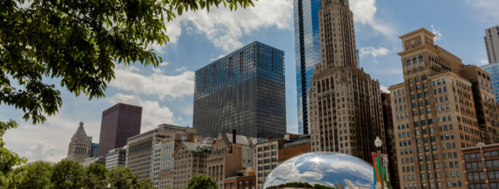 Cloud Gate Sculpture in Chicago, Illinois, with tourists and locals admiring its reflective surface and unique design