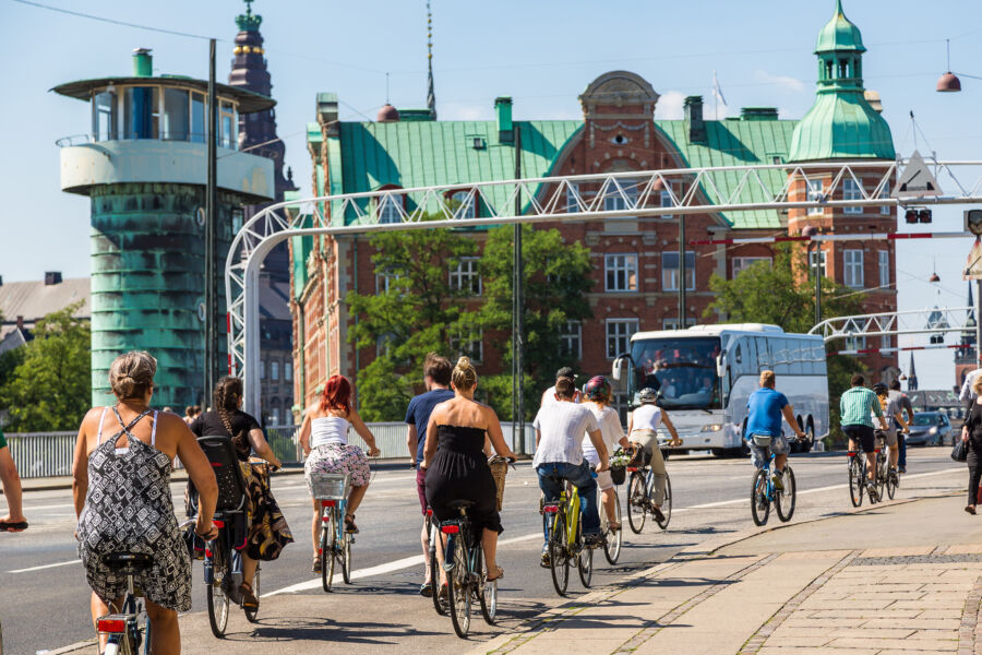 Cyclists navigating the vibrant streets of Copenhagen, Denmark, highlighting the city's commitment to sustainable transportation