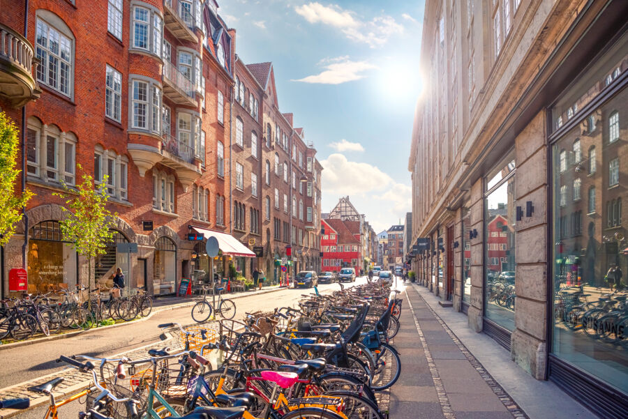 Many bicycles parked along the narrow Møntergade in Copenhagen's Old Town, showcasing the city's cycling culture