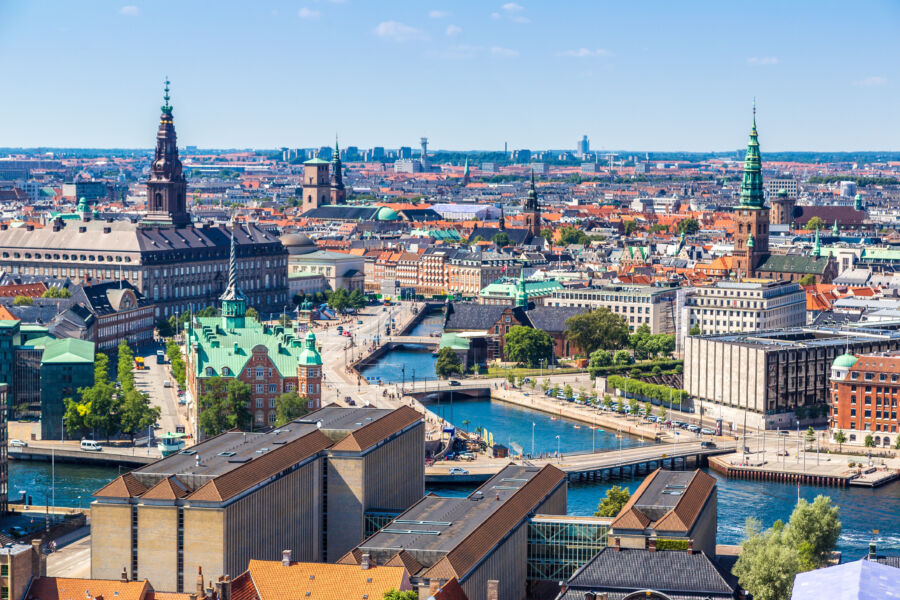 Stunning cityscape of Copenhagen, Denmark, featuring historic buildings and modern structures against a clear sky