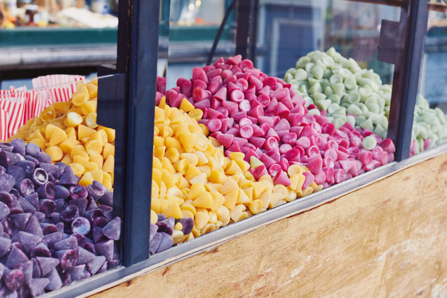 Traditional cone-shaped Belgian candy, Cuberdon, available for sale, showcasing its unique shape and vibrant color 