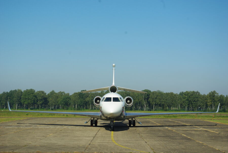 Front view of a Dassault Falcon 7X, a three-engine long-range corporate jet, showcasing its sleek design