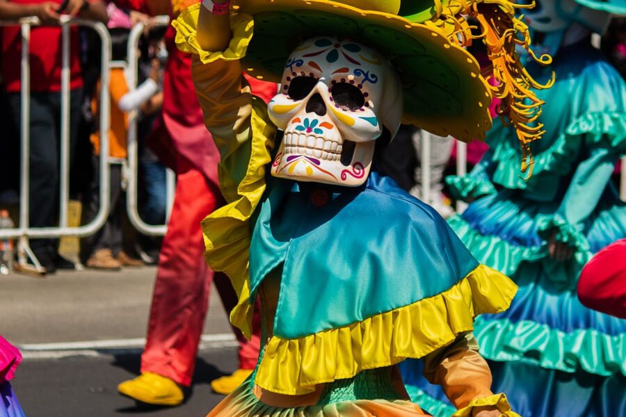 Day of the Dead celebration with colorful sugar skull costumes and vibrant parade.