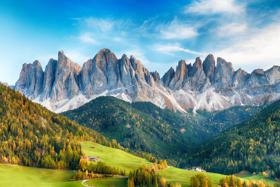 Scenic view of the Italian Dolomites featuring Santa Maddalena, showcasing majestic mountains and lush green valleys.
