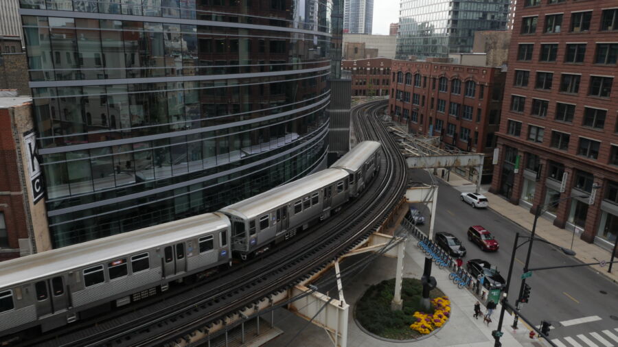 Downtown Chicago showcasing cars and a Chicago Transit Authority train amidst the urban landscape 