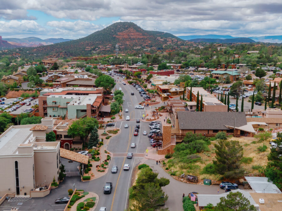 Scenic view of Downtown Sedona nestled among the stunning desert mountains of Arizona, showcasing vibrant red rock formations