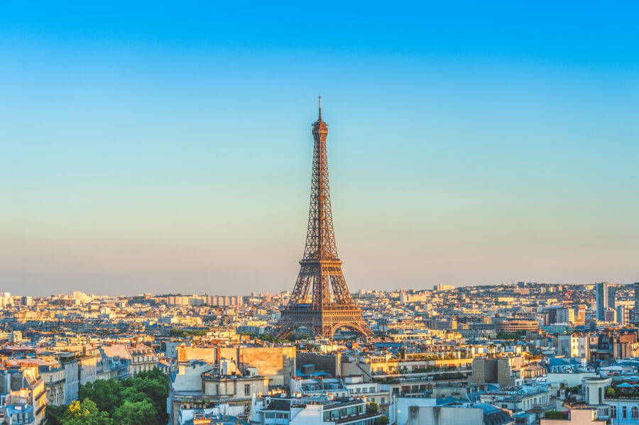 Paris skyline at dusk, highlighting the Eiffel Tower surrounded by a serene and colorful evening atmosphere.