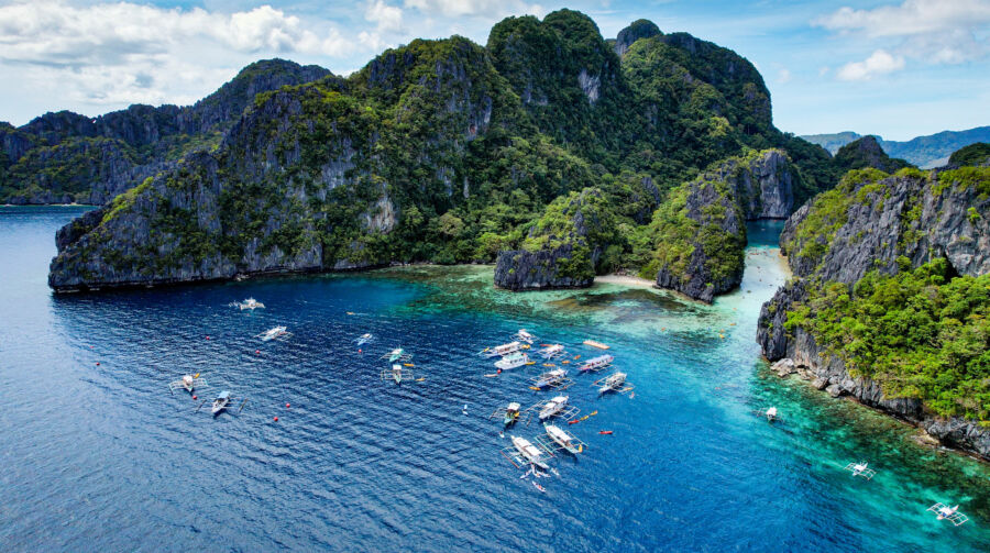 Aerial view of The Big Lagoon in El Nido, showcasing its turquoise waters and surrounding lush greenery in Palawan, Philippines