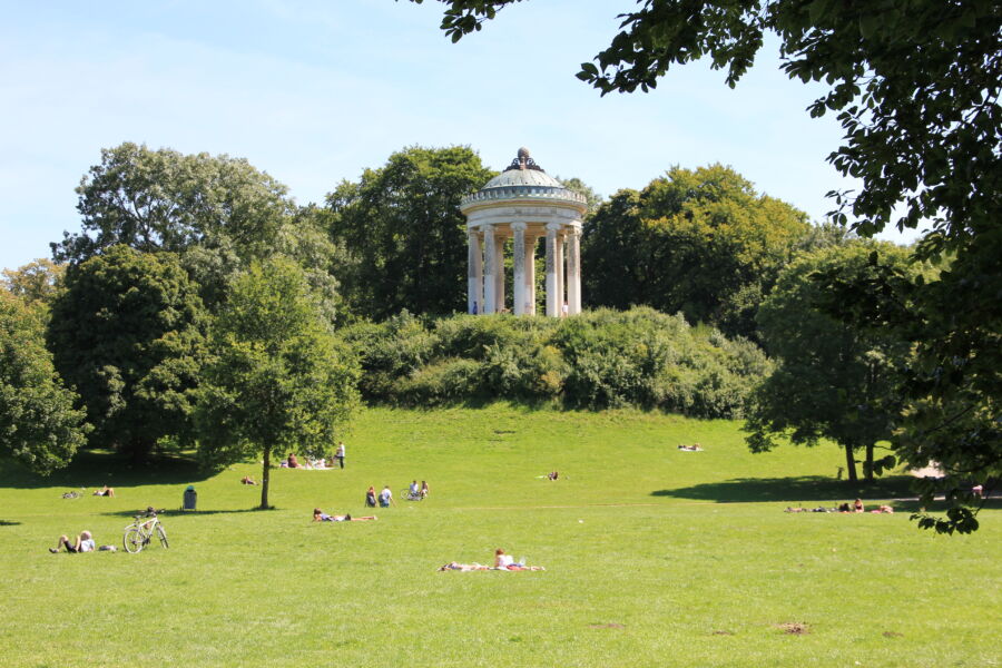 Panoramic view of the Monopteros temple in the English Garden, Munich, showcasing its classical architecture and surrounding greenery