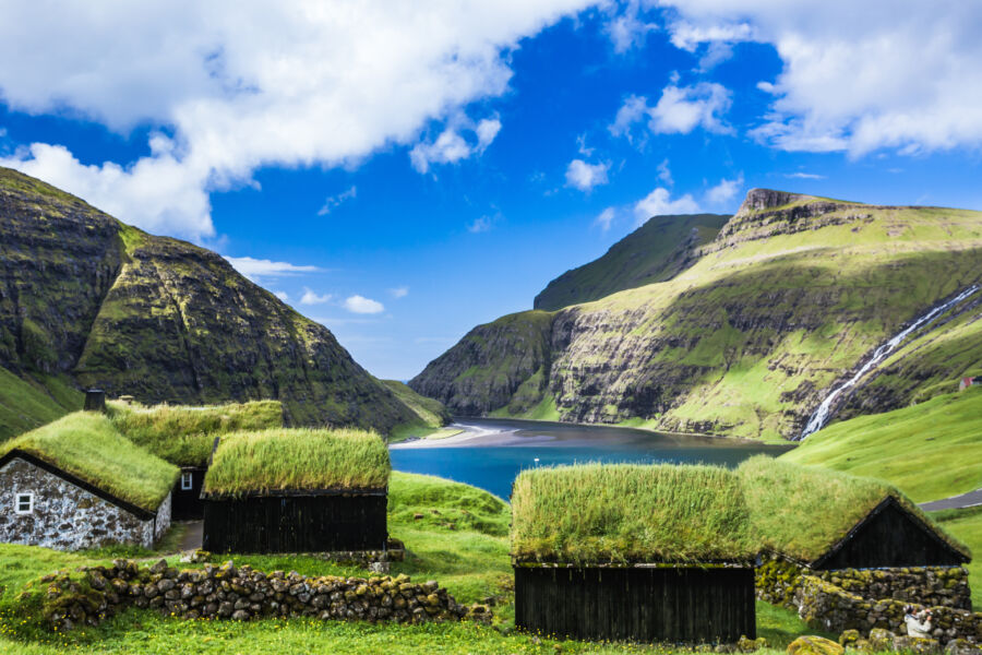 Scenic view of Saksun village in the Faroe Islands, showcasing traditional houses and dramatic landscapes