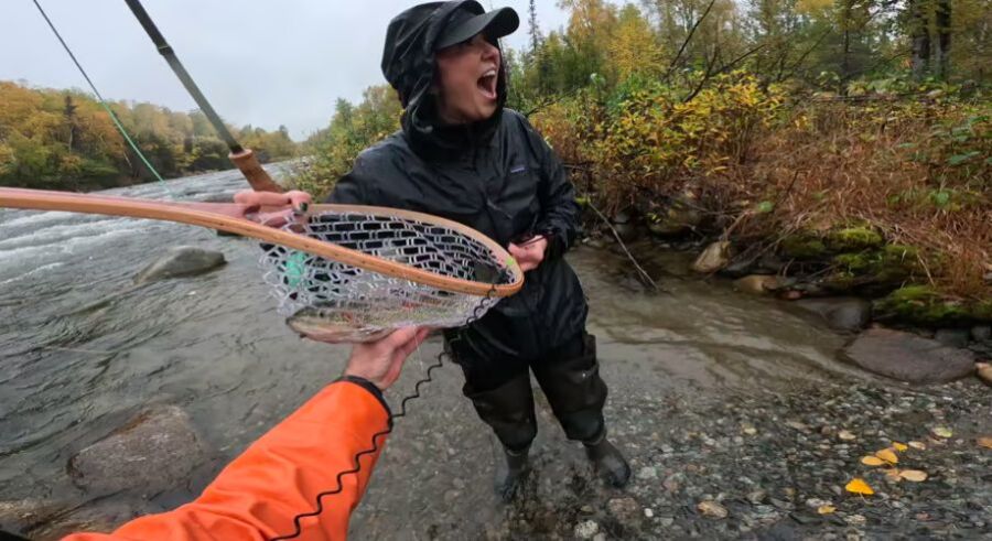 Angler catching trout by autumn river, outdoor adventure, fishing guide experience.