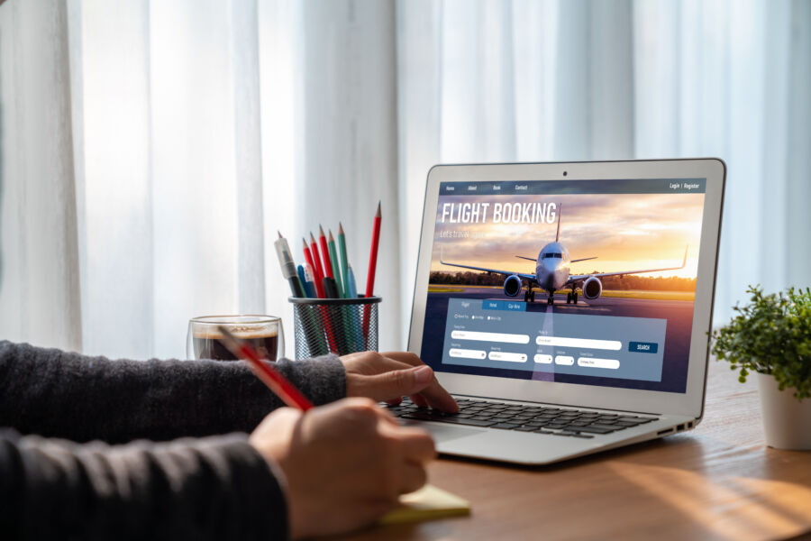 Laptop screen showcasing an online flight booking platform, highlighting booking features