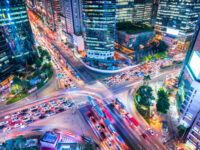 Night aerial view of Gangnam District in Seoul, South Korea, showcasing a vibrant skyline illuminated by city lights