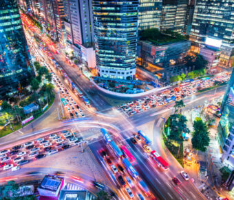 Night aerial view of Gangnam District in Seoul, South Korea, showcasing a vibrant skyline illuminated by city lights