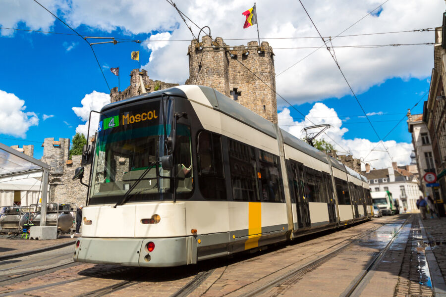 City tram in Gent, Belgium, glides along the streets on a sunny summer day, showcasing the charm of the city