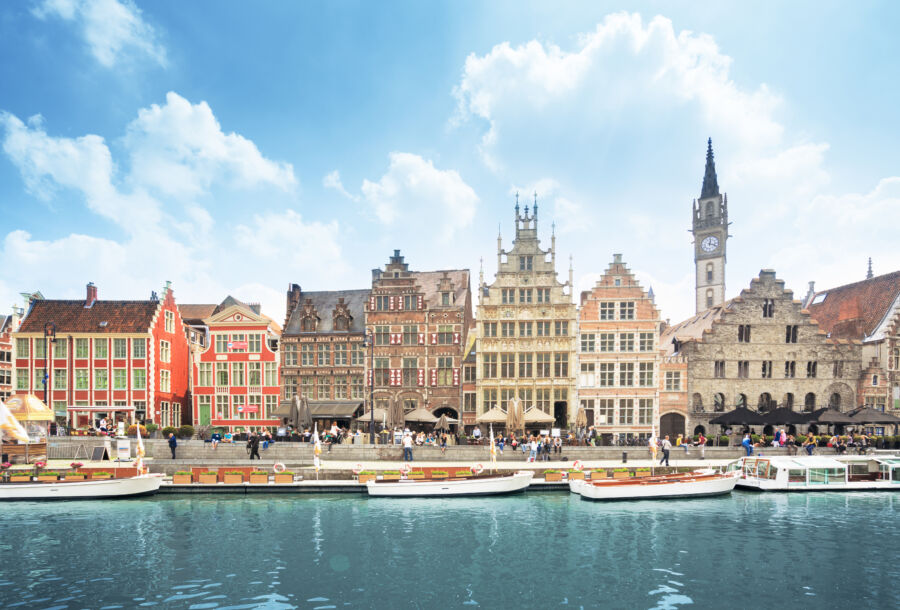 Panoramic view of a historic building along the river in the old town of Ghent, Belgium, showcasing its architectural beauty