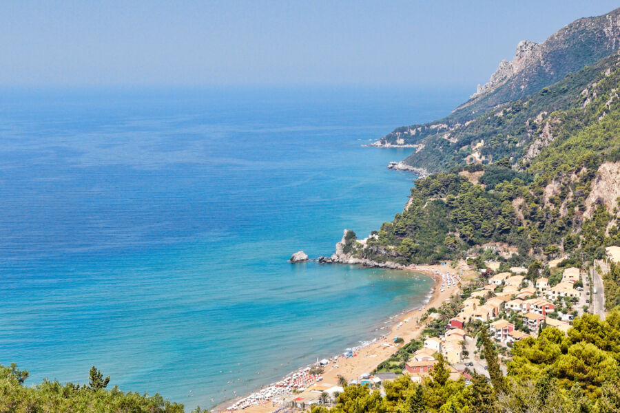 Aerial view of Glyfada Beach in Corfu, Greece, showcasing its stunning coastline and vibrant blue waters