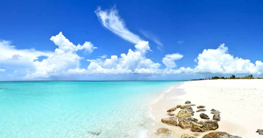 Idyllic scene of Grace Bay, Turks & Caicos, featuring a peaceful ocean view and skyline, representing an uncrowded paradise