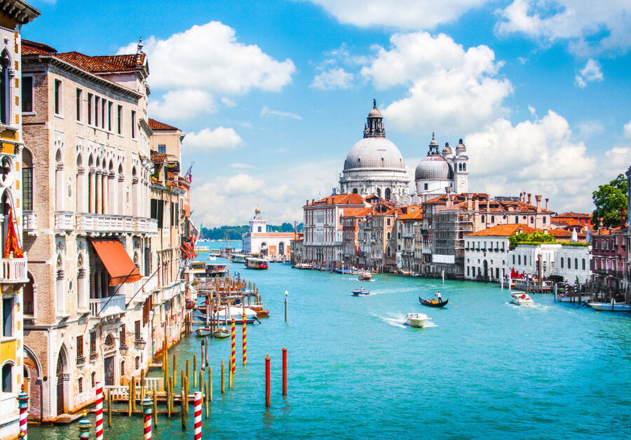 Panoramic view of the Grand Canal with Basilica Santa Maria della Salute in Venice, Italy, showcasing stunning architecture.