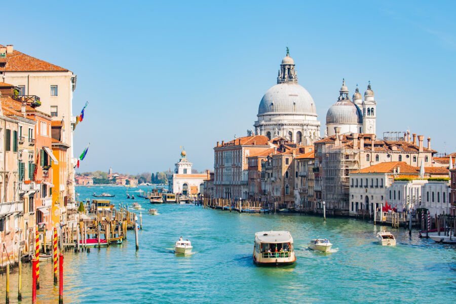 Scenic view of the Grand Canal in Venice, Italy, featuring a vaporetto ride against a picturesque skyline