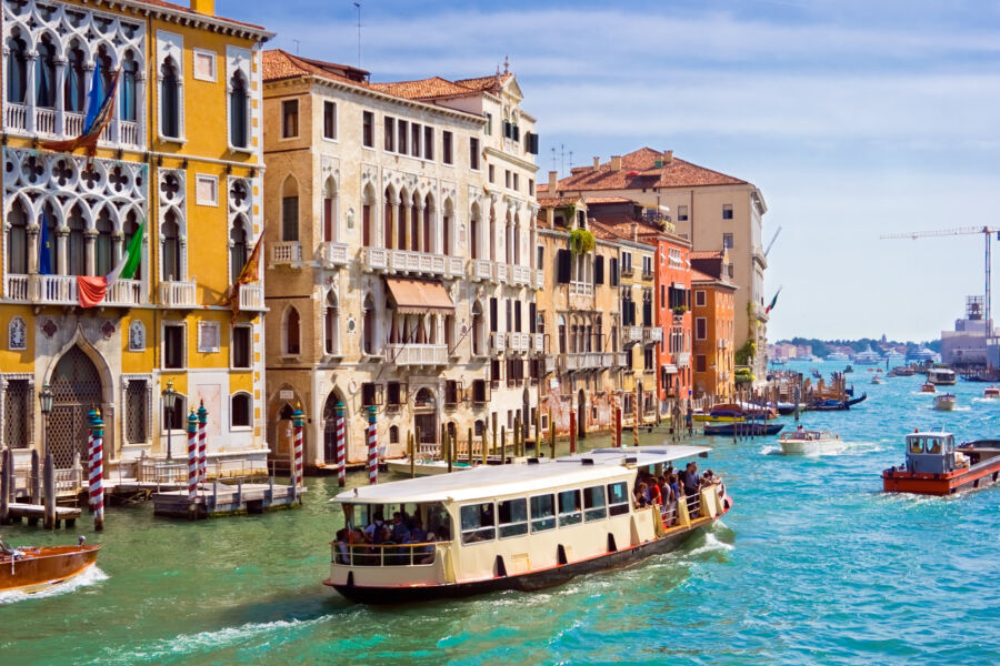 Panoramic view of the Grand Canal in Venice, showcasing vaporetti navigating the iconic waterways