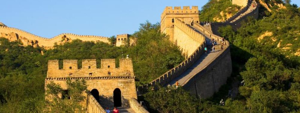 Sunny day at the Great Wall of China with tourists exploring the ancient landmark