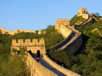 Sunny day at the Great Wall of China with tourists exploring the ancient landmark