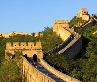 Sunny day at the Great Wall of China with tourists exploring the ancient landmark