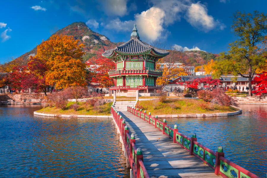 Autumn at Gyeongbokgung Palace, featuring vibrant foliage, a tranquil lake in Seoul, South Korea