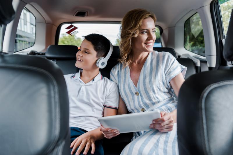 Happy kid in headphones near mother