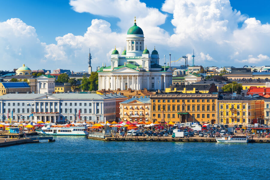 Panoramic view of Helsinki, Finland, showcasing its stunning architecture and vibrant waterfront against a clear blue sky