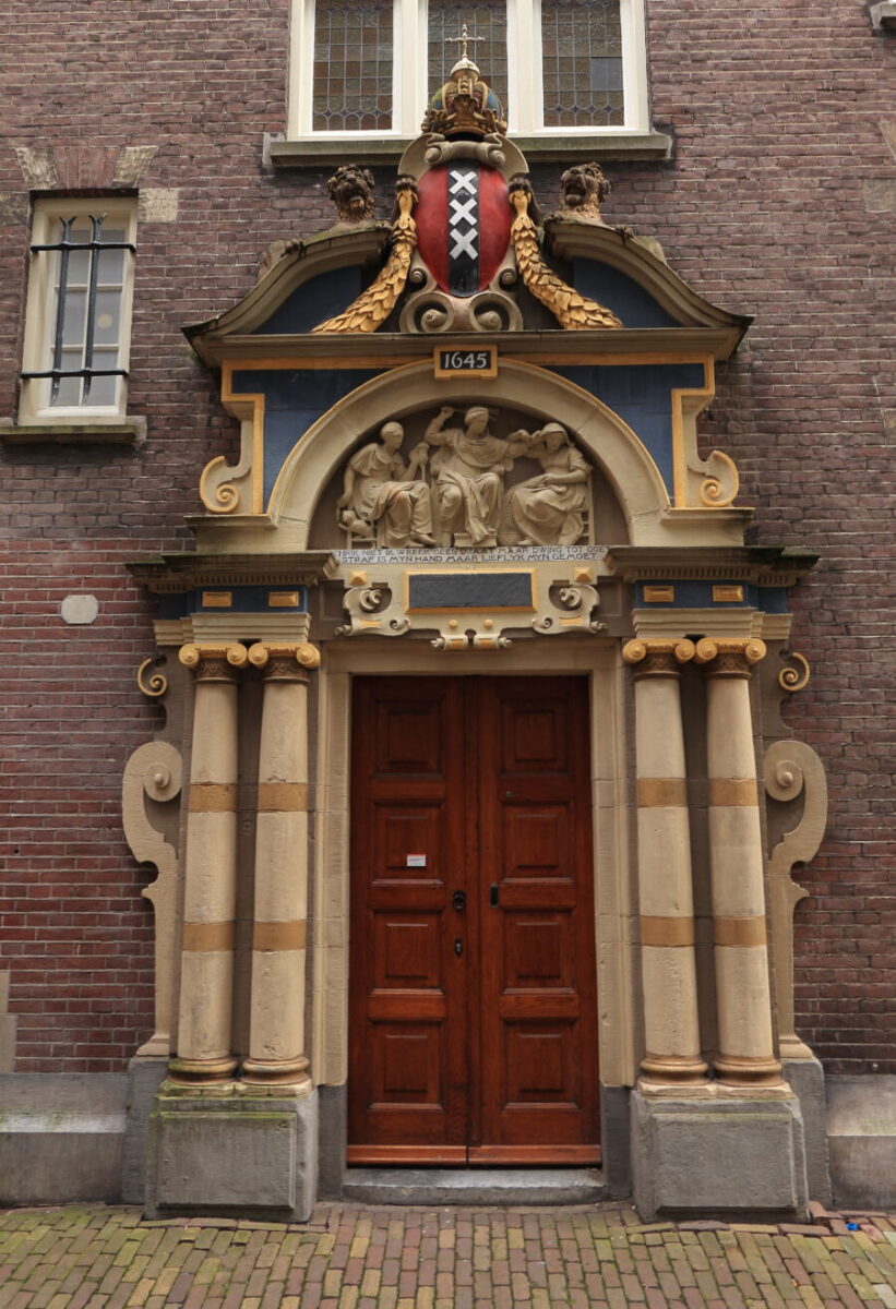 Sculpted entrance of the Amsterdam Historical Spinhuis Building, showcasing intricate architectural details in the Netherlands