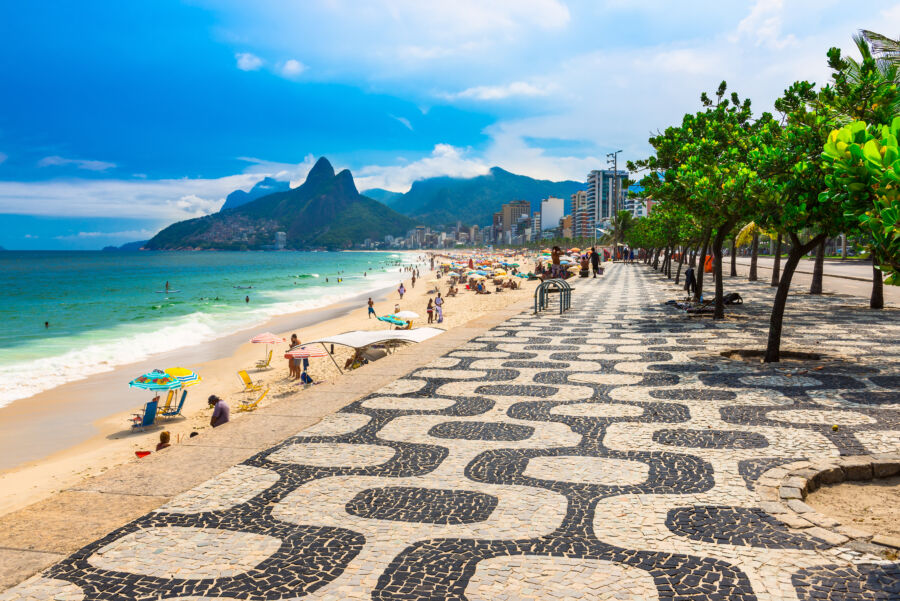 Scenic Ipanema Beach in Rio de Janeiro, showcasing a colorful mosaic sidewalk along the shoreline