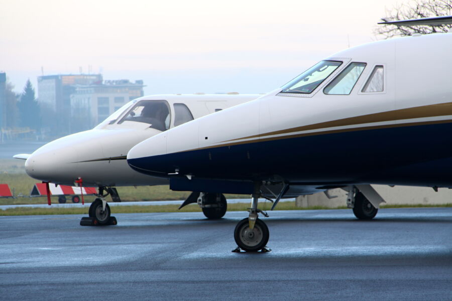 Close-up view of a private jet's nose, showcasing its sleek design and polished surface