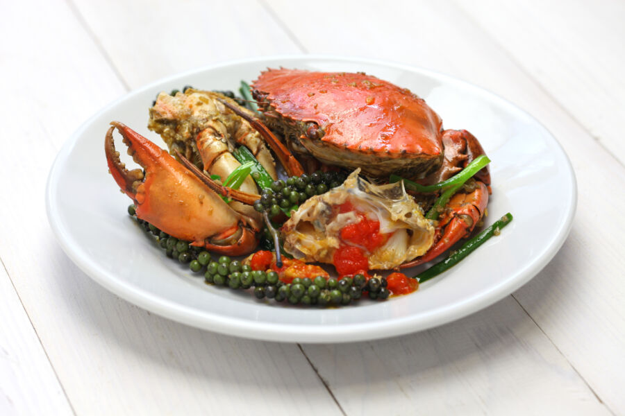 Stir-fried crab with green Kampot pepper, showcasing vibrant colors and flavors of Cambodian cuisine