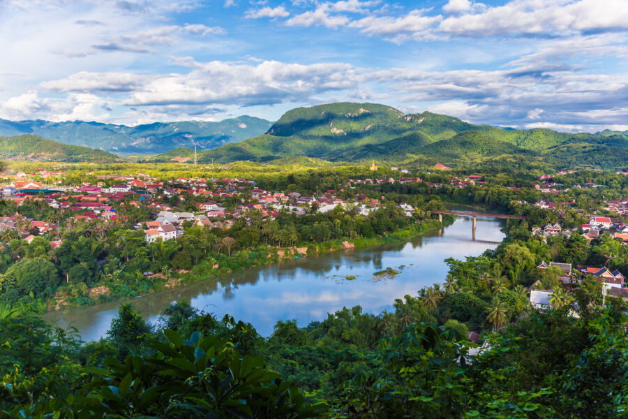 Scenic view of the Khan River in Luang Prabang, Laos, showcasing the river and the surrounding urban landscape