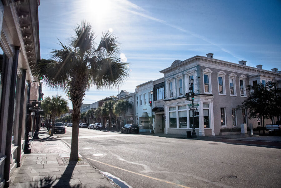 Panoramic view of a sunny King Street in Charleston, South Carolina, showcasing vibrant shops