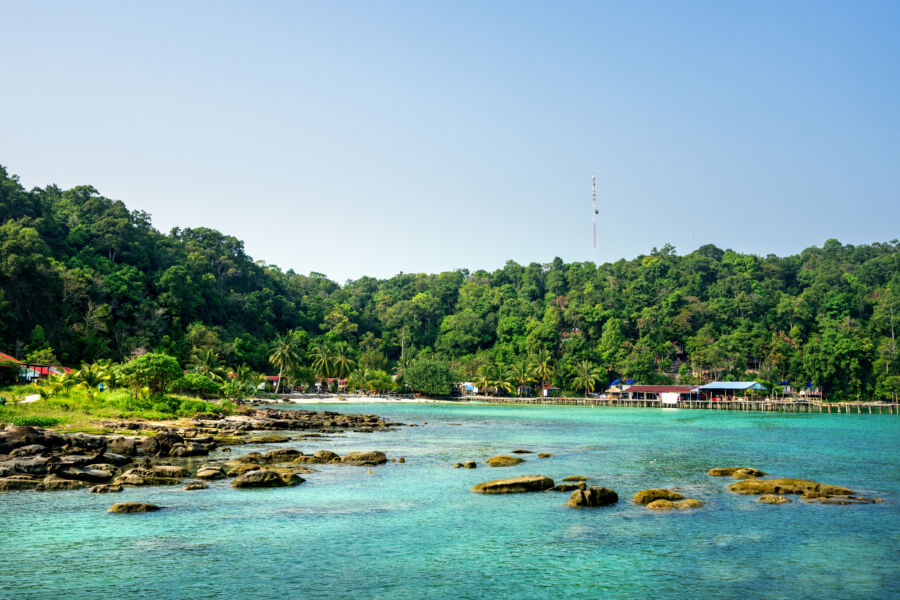 Scenic view of Koh Rong Samloem Island's beautiful beach in Sihanoukville, Cambodia, with clear blue waters and soft sand