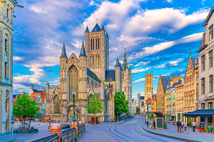 Historical center of Ghent featuring Saint Nicholas Church, Belfry, and colorful buildings on Korenmarkt Wheat Market square