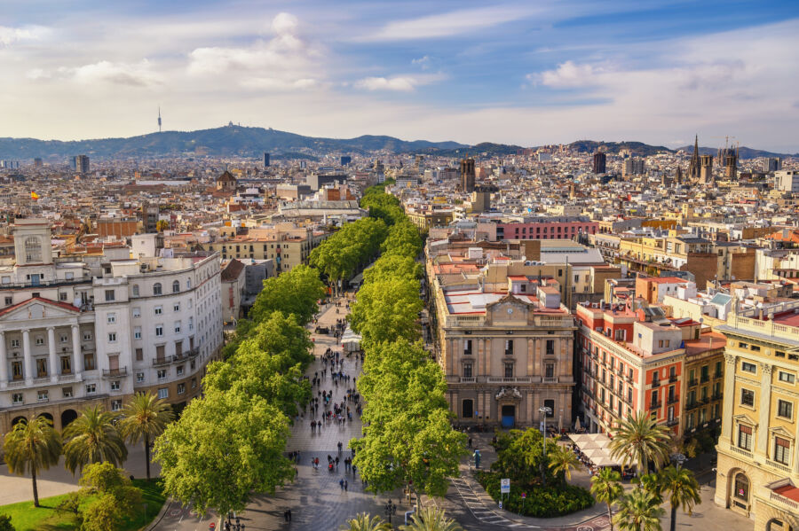 Aerial view of Barcelona's skyline showcasing La Rambla street, highlighting the city's vibrant architecture and urban landscape