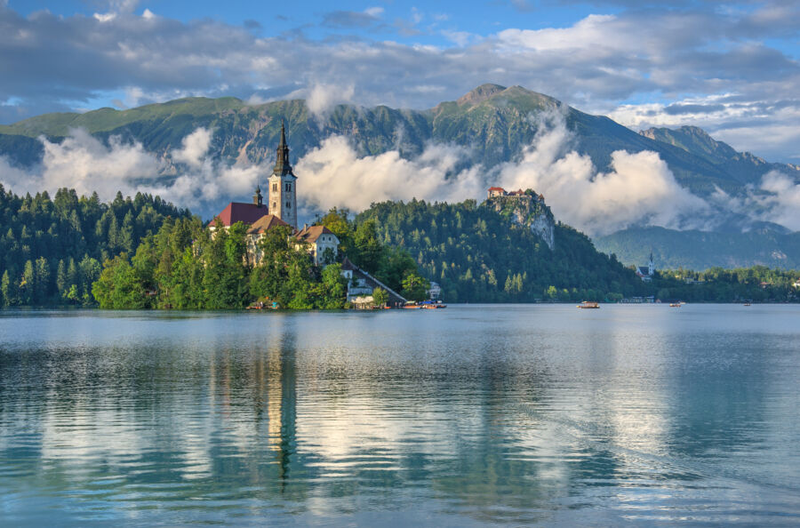 Panoramic view of Lake Bled, Slovenia, showcasing the serene lake, island church, and surrounding mountains