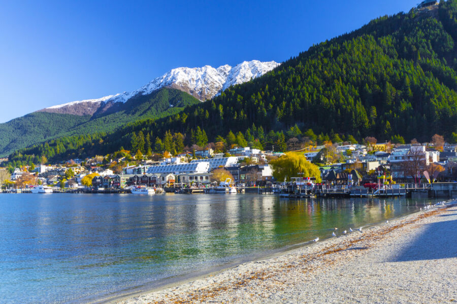 Scenic landscape of Lake Wakatipu, surrounded by breathtaking mountains in Queenstown, New Zealand