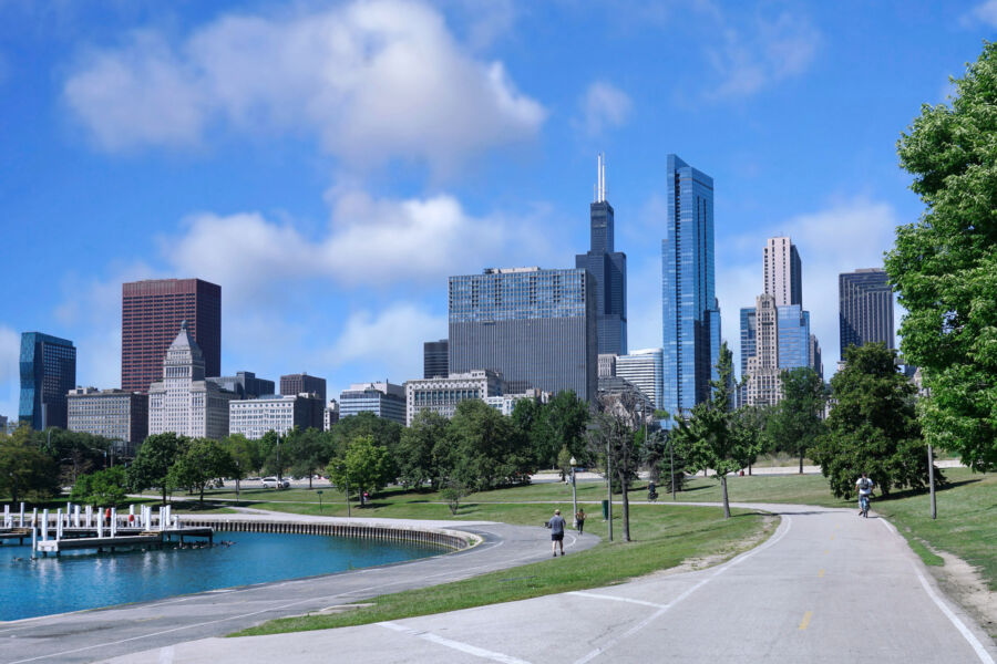 Scenic view of the Chicago Lakefront Trail near Monroe Street, featuring lush greenery and a vibrant skyline