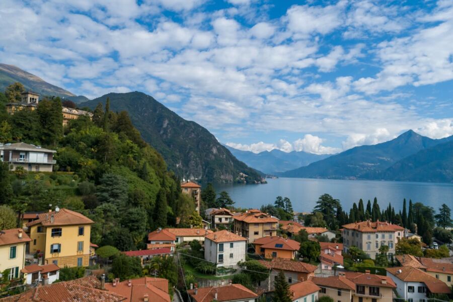 Picturesque Italian lakeside village with mountains, traditional architecture, and serene waters.