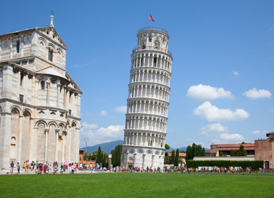 The Leaning Tower of Pisa stands prominently against the Italian skyline, showcasing its unique tilt and architectural beauty.