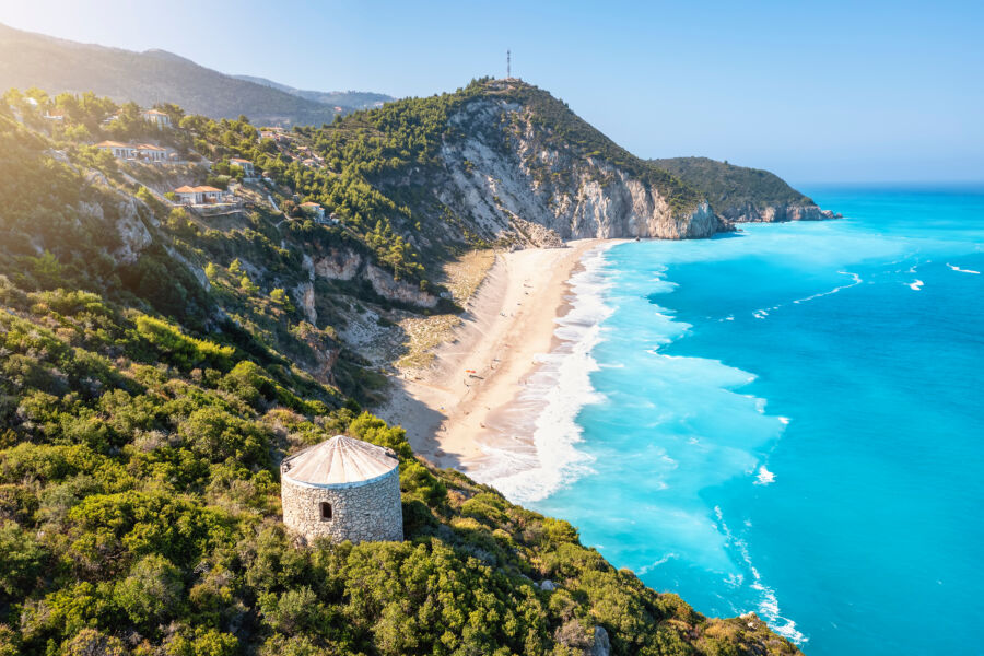 Turquoise waters of Milos beach on Lefkada Island, surrounded by stunning natural beauty in the Ionian Sea, Greece.